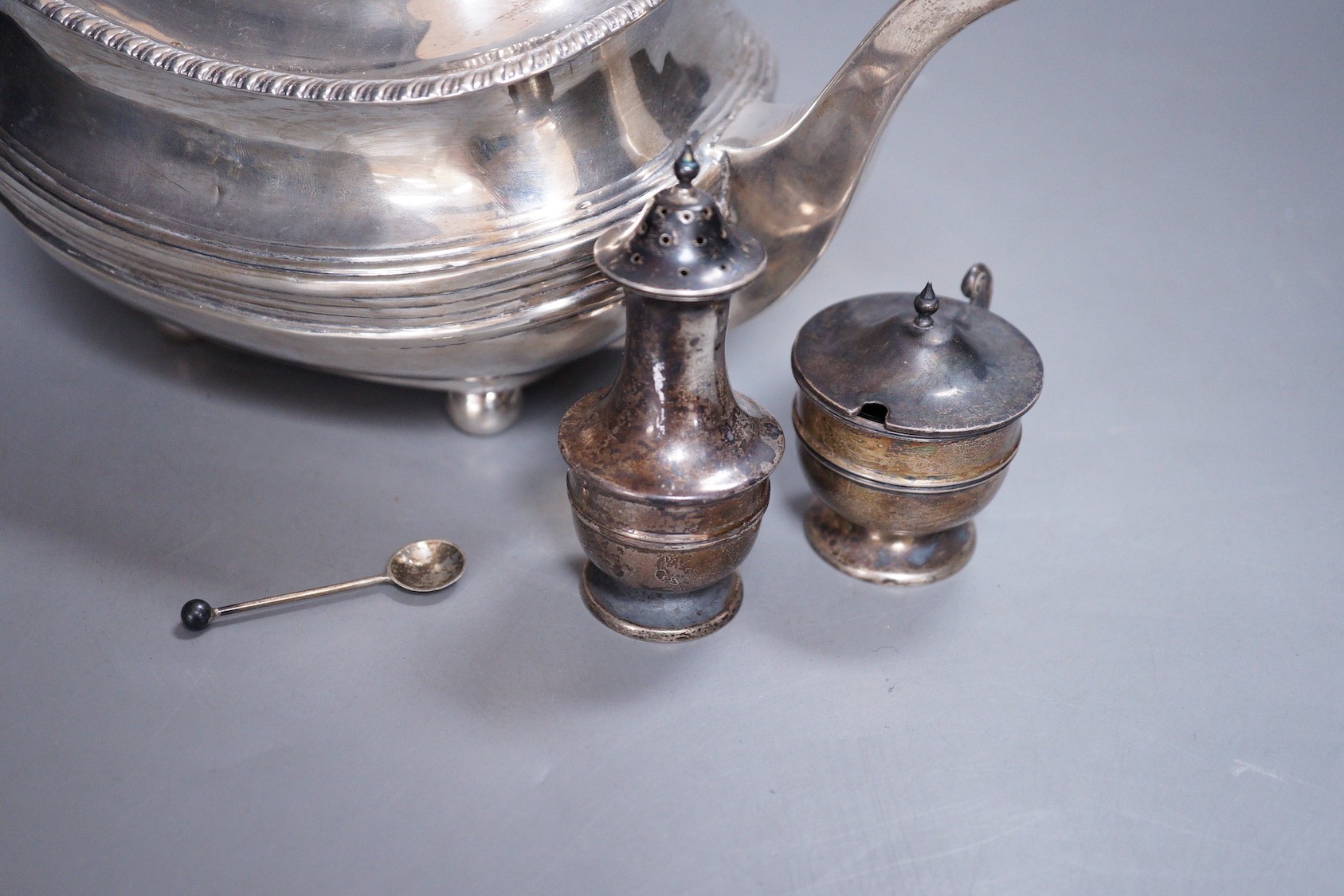 A Georgian silver teapot, (marks rubbed and repaired) and two Edwardian silver condiments, gross weight 23.3oz.